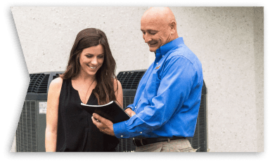 An HVAC tech talking to a customer