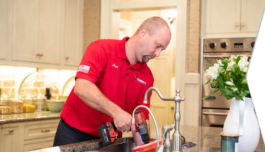 expert plumber fixing a kitchen sink